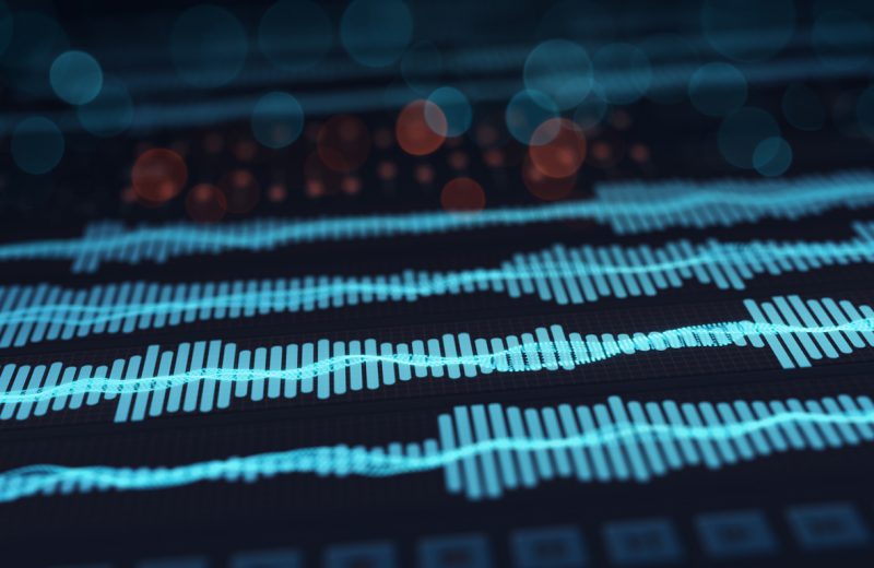 Digital audio waves on screen. Computer designed abstract technology rendering with DOF